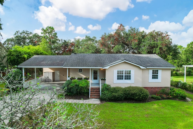 single story home featuring a front lawn, a carport, and covered porch