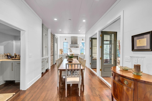 dining room with ornamental molding and dark hardwood / wood-style floors