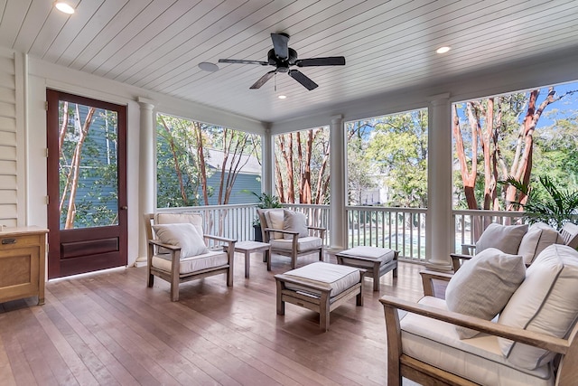 sunroom / solarium with wood ceiling, ornate columns, and ceiling fan