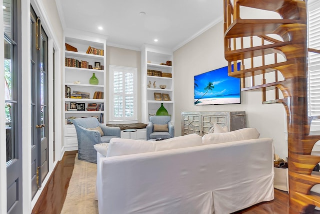 living room with built in features, ornamental molding, dark hardwood / wood-style flooring, and plenty of natural light