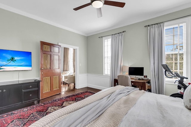 bedroom with ornamental molding, hardwood / wood-style flooring, and ceiling fan