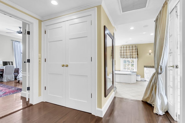 hallway with crown molding and hardwood / wood-style floors