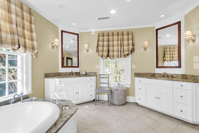 bathroom featuring vanity, crown molding, a tub to relax in, and tile patterned flooring