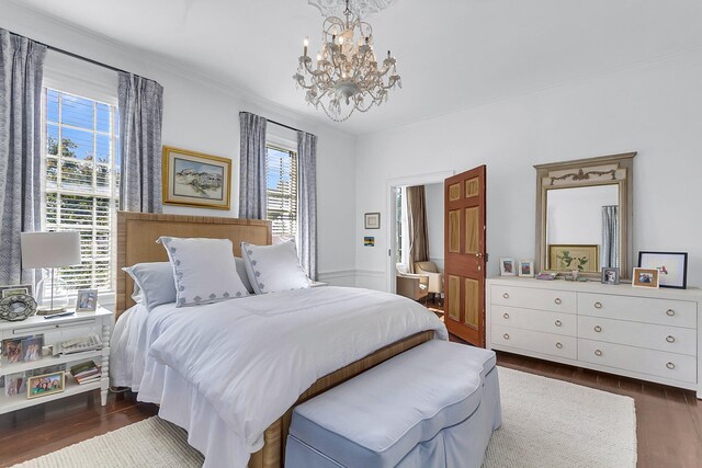 bedroom with dark wood-type flooring, multiple windows, and an inviting chandelier