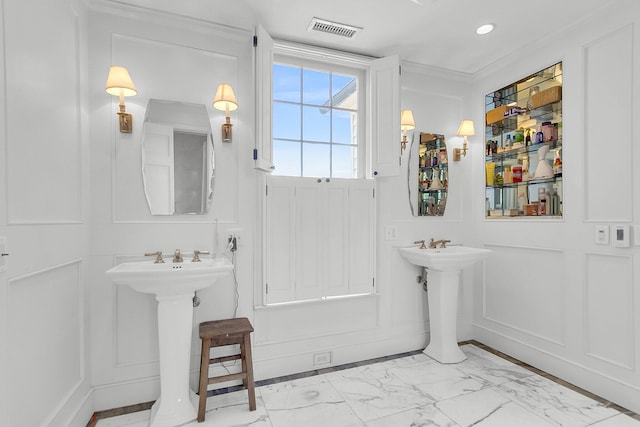 bathroom with sink and crown molding