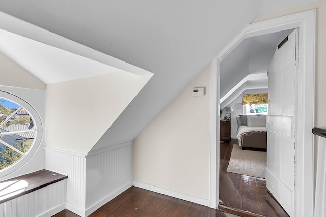 additional living space with lofted ceiling and dark hardwood / wood-style flooring