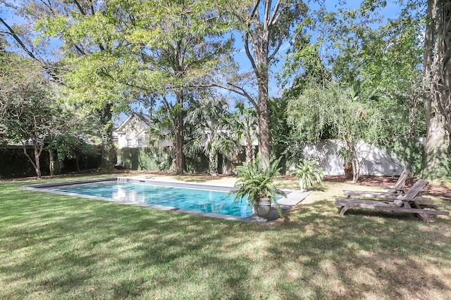 view of pool with a lawn