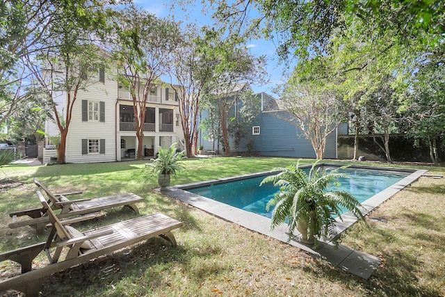 view of pool featuring a lawn