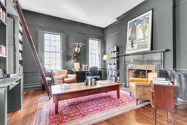 interior space featuring a premium fireplace, ornamental molding, and dark hardwood / wood-style flooring