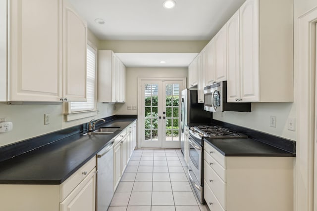 kitchen featuring white cabinetry, light tile patterned floors, french doors, sink, and appliances with stainless steel finishes