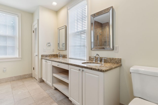 bathroom with vanity, toilet, and a wealth of natural light