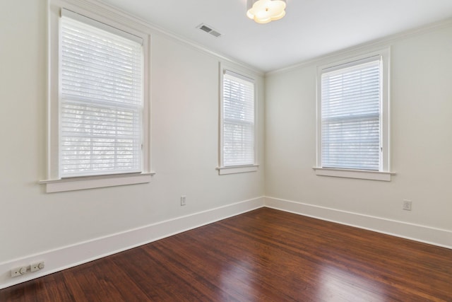 unfurnished room featuring wood-type flooring, a wealth of natural light, and ornamental molding