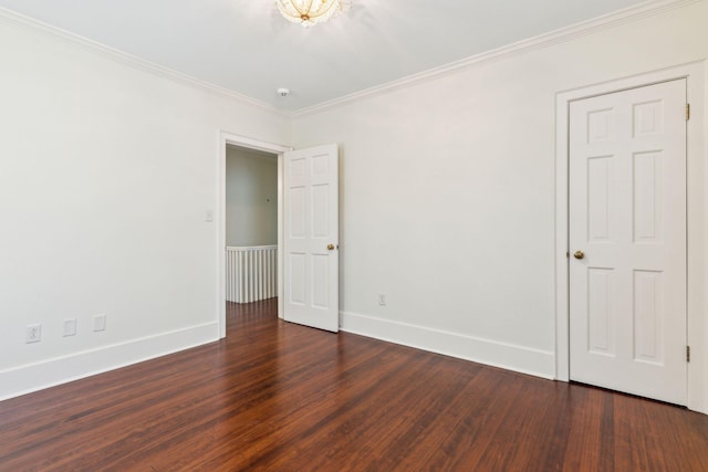 unfurnished room featuring ornamental molding and dark hardwood / wood-style floors