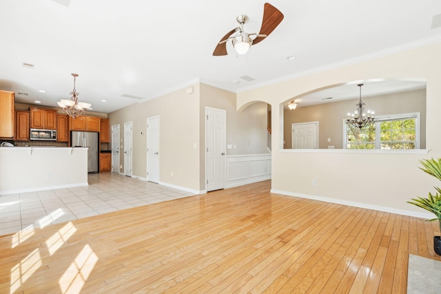489 Dolphin Dr, Summerville, SC 29485 - unfurnished living room with a chandelier, arched walkways, ceiling fan, ornamental molding, and light wood-type flooring