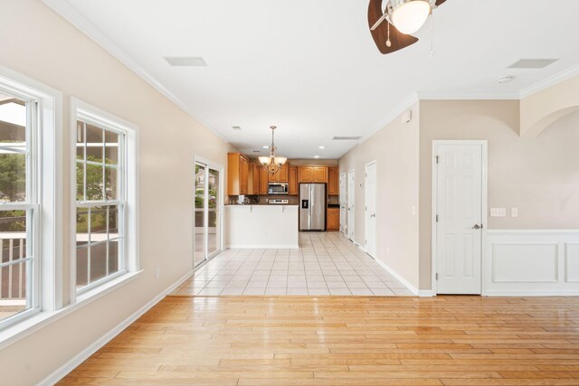 489 Dolphin Dr, Summerville, SC 29485 - unfurnished living room featuring ornamental molding, a chandelier, light wood finished floors, and a ceiling fan