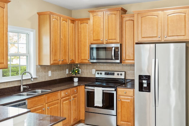489 Dolphin Dr, Summerville, SC 29485 - kitchen with appliances with stainless steel finishes, a sink, tasteful backsplash, and dark stone countertops