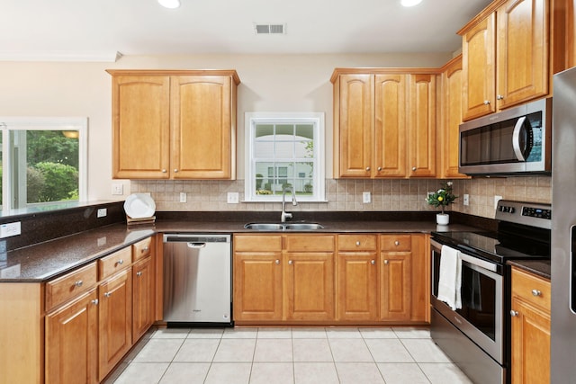 489 Dolphin Dr, Summerville, SC 29485 - kitchen with appliances with stainless steel finishes, a sink, a peninsula, tasteful backsplash, and light tile patterned flooring