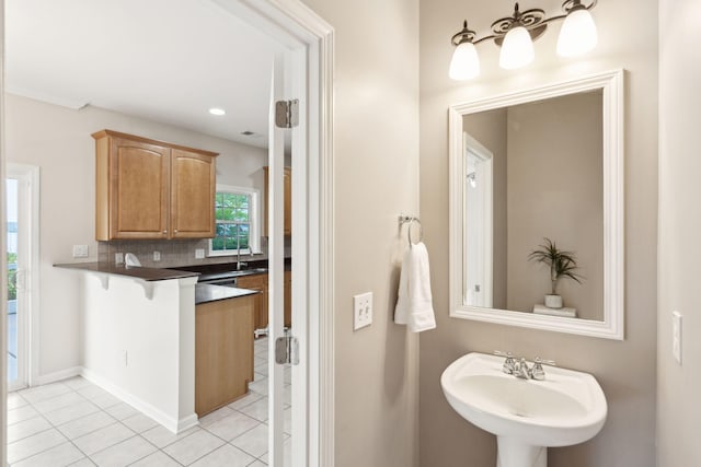 489 Dolphin Dr, Summerville, SC 29485 - bathroom with tile patterned floors, backsplash, a sink, and recessed lighting