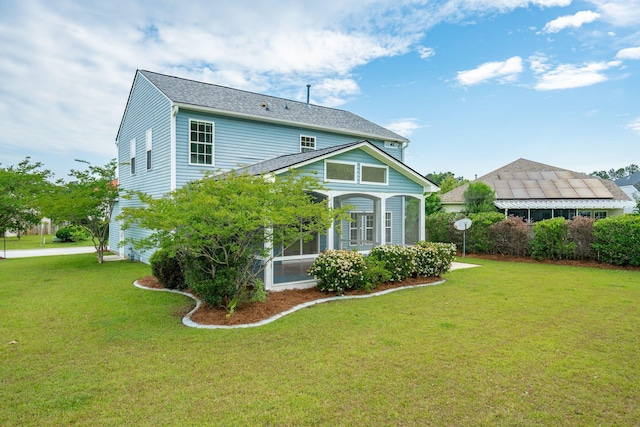 489 Dolphin Dr, Summerville, SC 29485 - rear view of house featuring a lawn, a sunroom, and a shingled roof