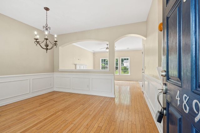 489 Dolphin Dr, Summerville, SC 29485 - entryway featuring arched walkways, light wood-type flooring, a wainscoted wall, a decorative wall, and a ceiling fan