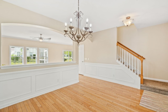 489 Dolphin Dr, Summerville, SC 29485 - unfurnished room featuring arched walkways, a wainscoted wall, plenty of natural light, ceiling fan, and stairway