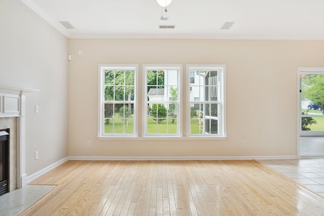 489 Dolphin Dr, Summerville, SC 29485 - unfurnished living room featuring crown molding, light wood-type flooring, a premium fireplace, and baseboards