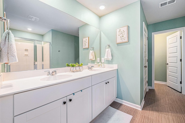 bathroom featuring vanity and a shower with shower door