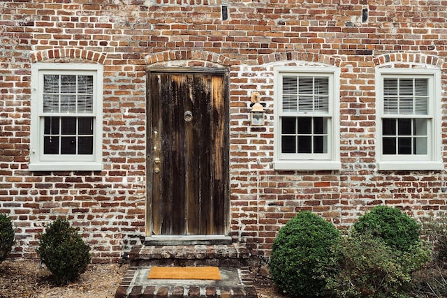 property entrance with brick siding