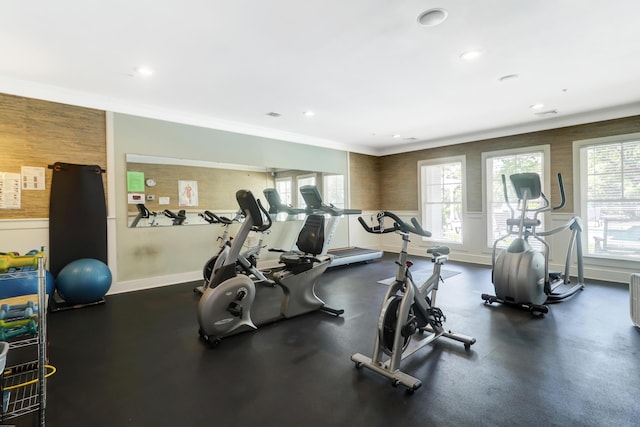 workout area featuring crown molding