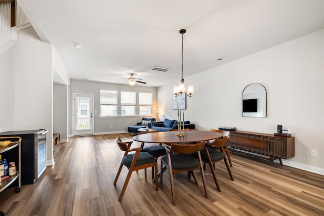 582 Mclernon Trce, Johns Island, SC 29455 - dining area featuring wood finished floors, baseboards, a ceiling fan, and a chandelier
