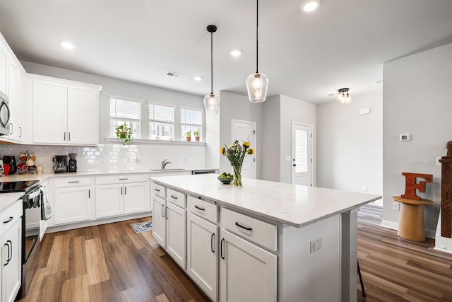 582 Mclernon Trce, Johns Island, SC 29455 - kitchen with electric range, backsplash, wood finished floors, a kitchen island, and a sink