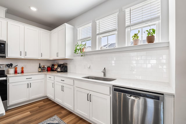 582 Mclernon Trce, Johns Island, SC 29455 - kitchen featuring appliances with stainless steel finishes, a sink, white cabinetry, backsplash, and light stone counters