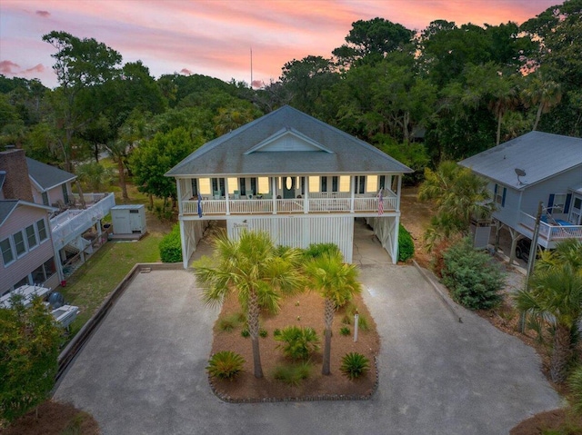 1604 Jungle Rd, Edisto Island, SC 29438 - view of front of property with a carport, asphalt driveway, and covered porch