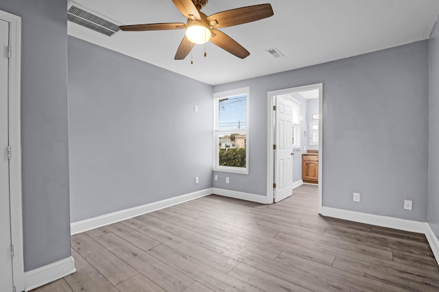 spare room with light wood-type flooring and ceiling fan