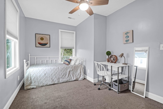 bedroom with lofted ceiling, multiple windows, ceiling fan, and carpet