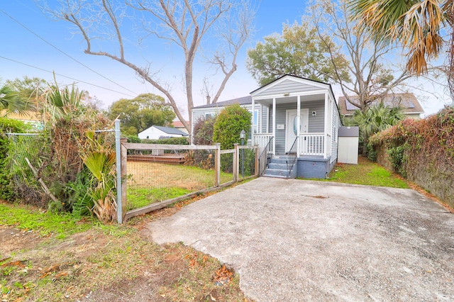 bungalow with a porch and a front lawn