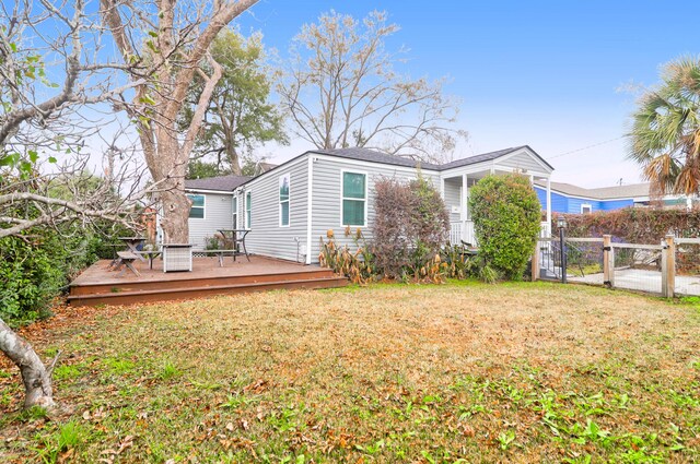 view of property exterior with a wooden deck and a lawn