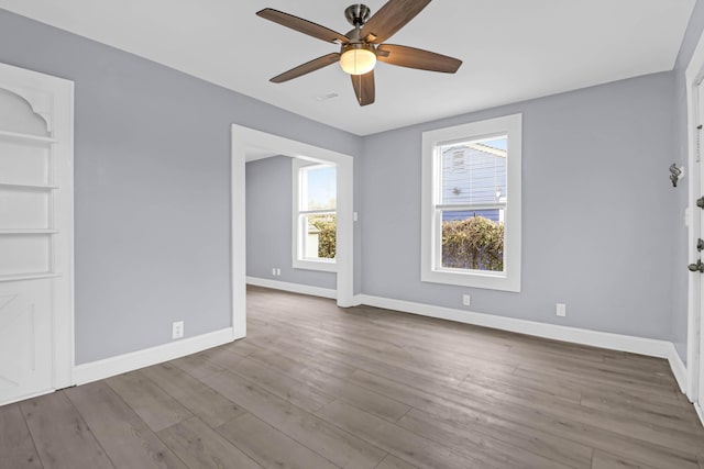 unfurnished room with ceiling fan and wood-type flooring