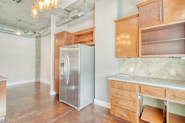 kitchen featuring tasteful backsplash, decorative light fixtures, built in desk, stainless steel fridge with ice dispenser, and a notable chandelier