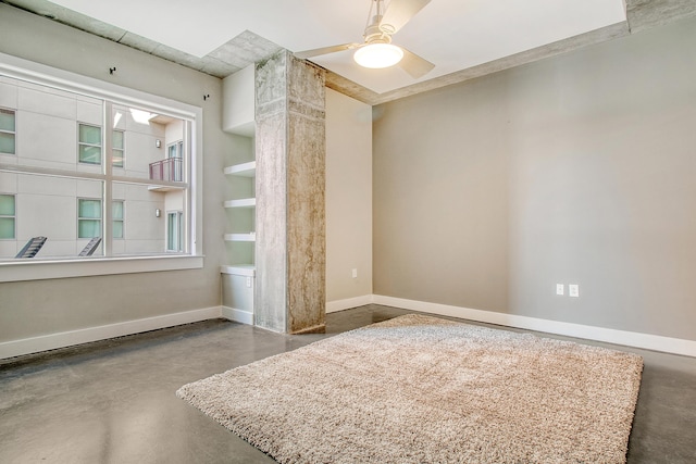 spare room featuring ceiling fan and concrete flooring