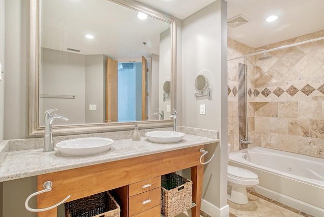 full bathroom featuring tiled shower / bath combo, vanity, tile patterned flooring, and toilet