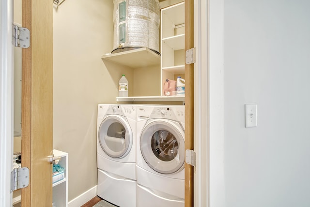 clothes washing area featuring washer and clothes dryer