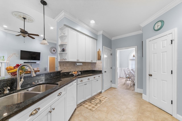 kitchen featuring pendant lighting, white cabinetry, sink, dark stone counters, and white dishwasher