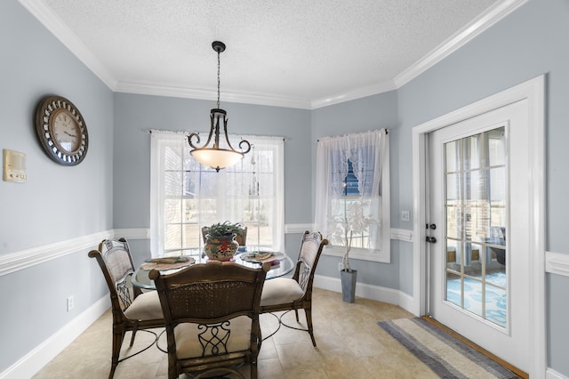 dining area with crown molding and a textured ceiling