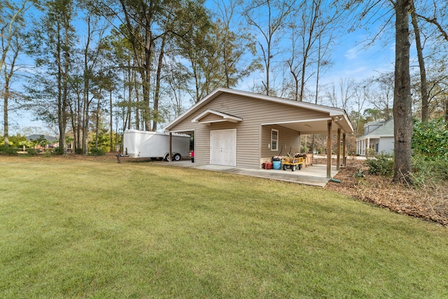 back of house with a lawn and a patio