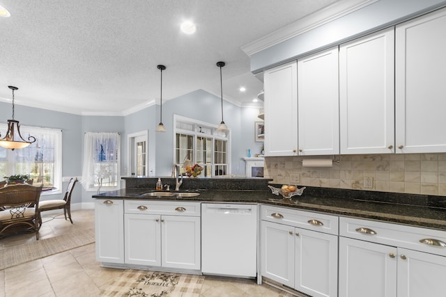 kitchen featuring hanging light fixtures, sink, white cabinets, and white dishwasher