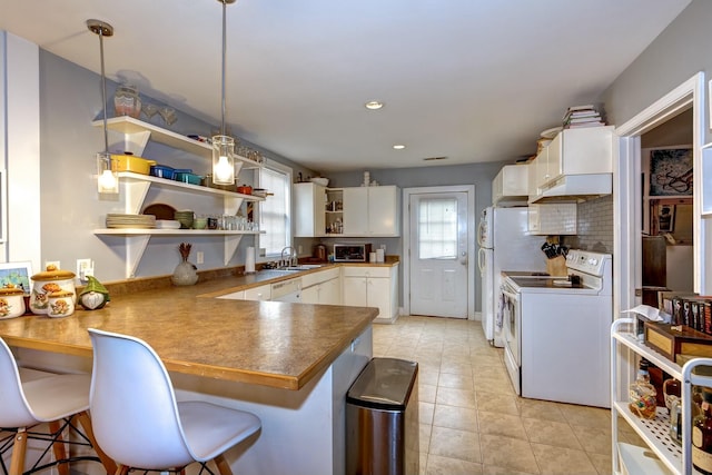 kitchen featuring white appliances, a peninsula, open shelves, a sink, and white cabinetry