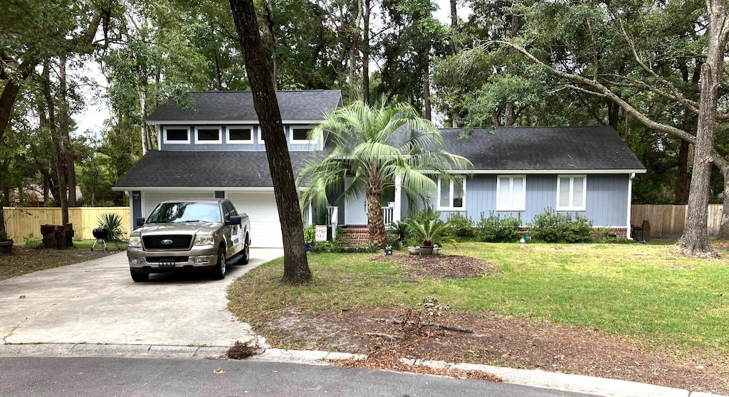 view of front of house featuring a garage and a front lawn