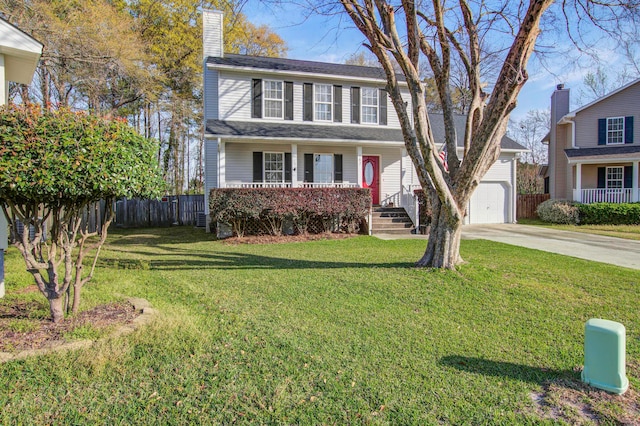 view of front facade with a garage, a porch, and a front yard