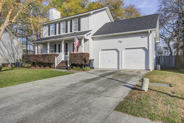 view of front of property with a front lawn, a garage, and a porch